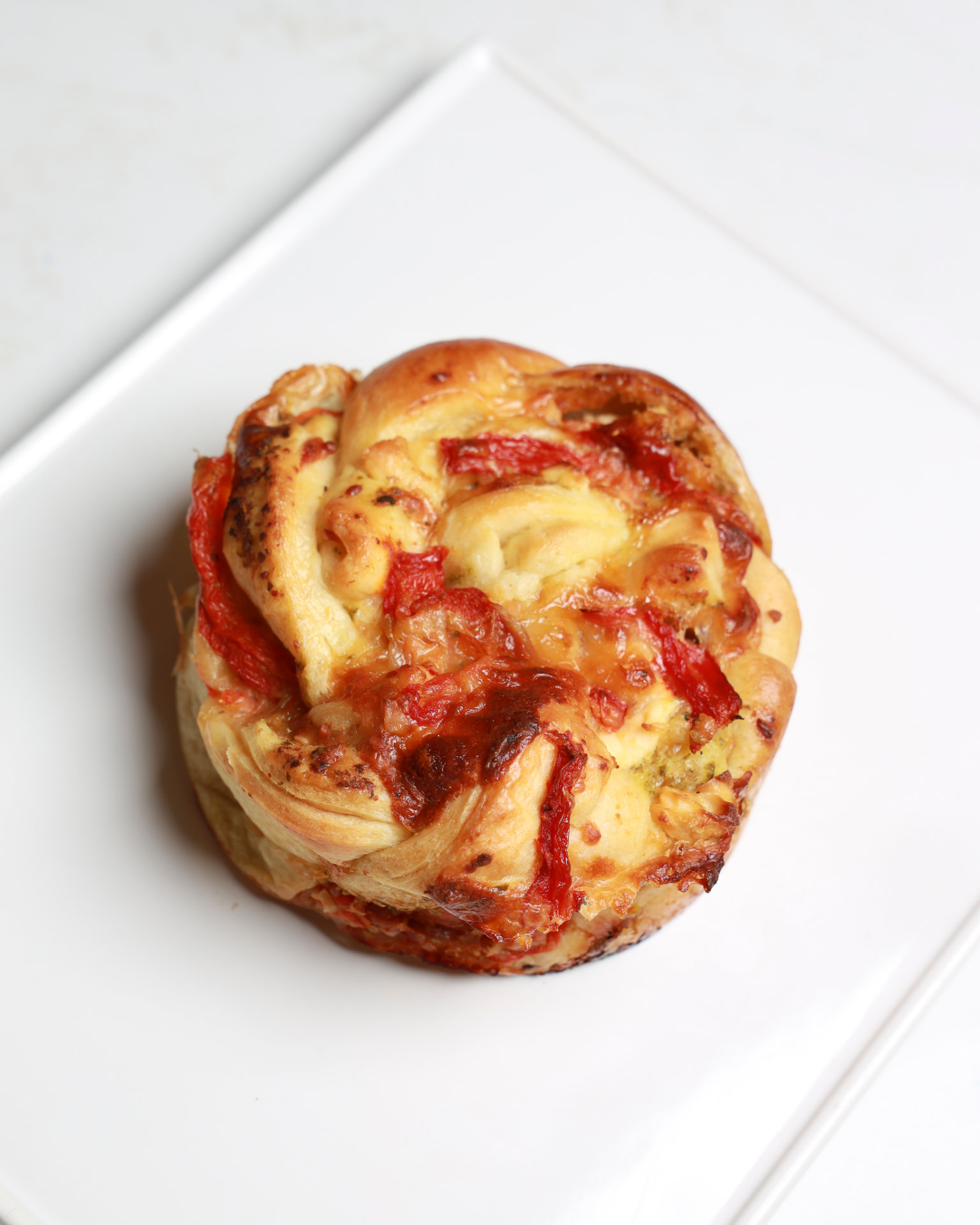 Cheese and Roasted Pepper Twist pastry on a ceramic plate