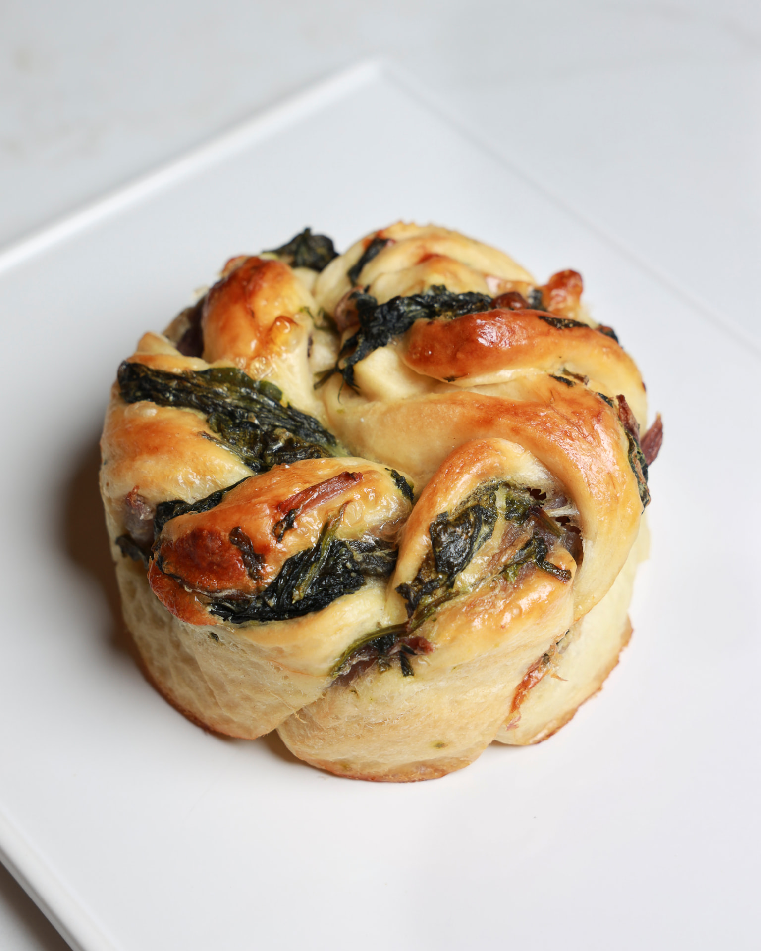 Cheese and Spinach Twist pastry on a ceramic plate