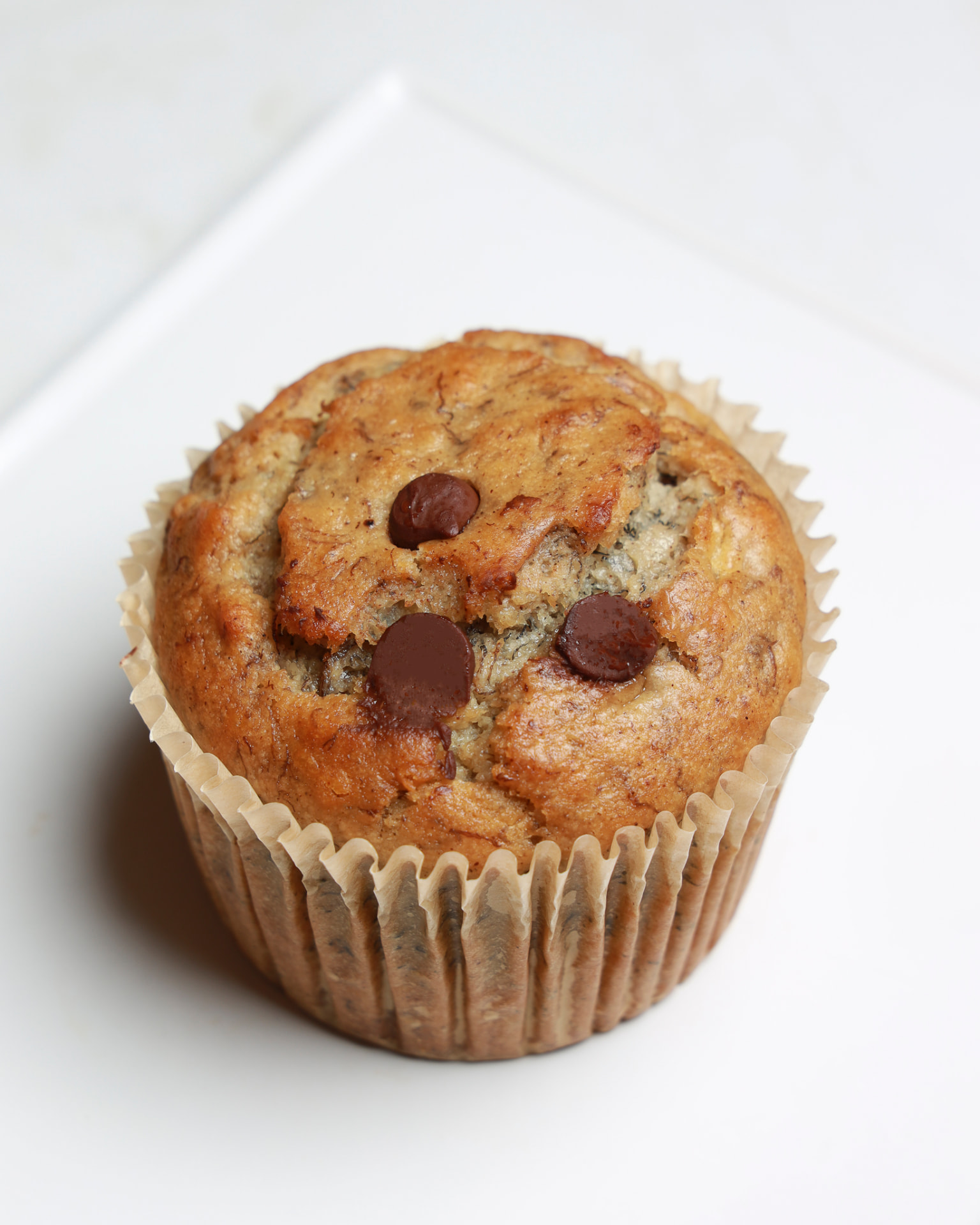 Banana Chocolate Chip Muffin (Vegan) pastry on a ceramic plate